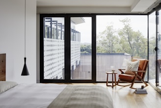 brown wooden armchair near glass window