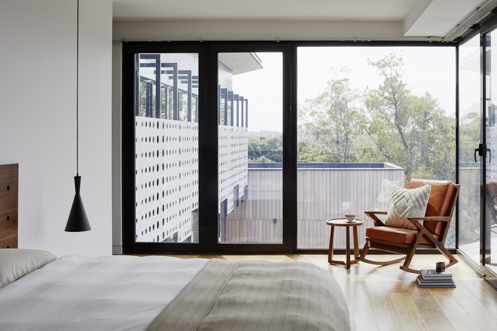 brown wooden armchair near glass window