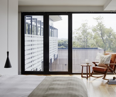 brown wooden armchair near glass window