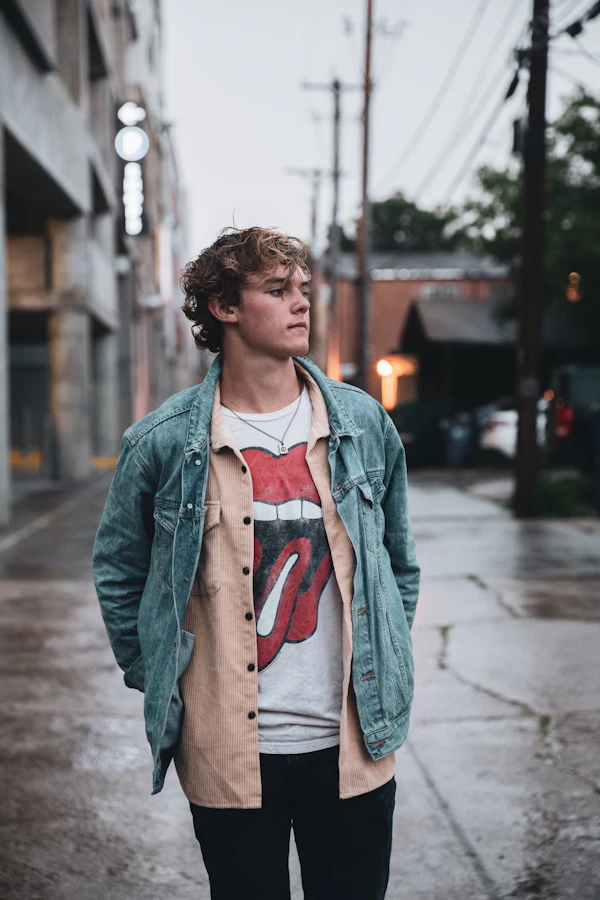 Man in a grey jacket on a sidewalk
