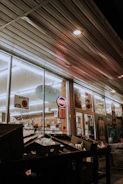 Nighttime exterior shot of a retail store with visible security cameras and lighting.