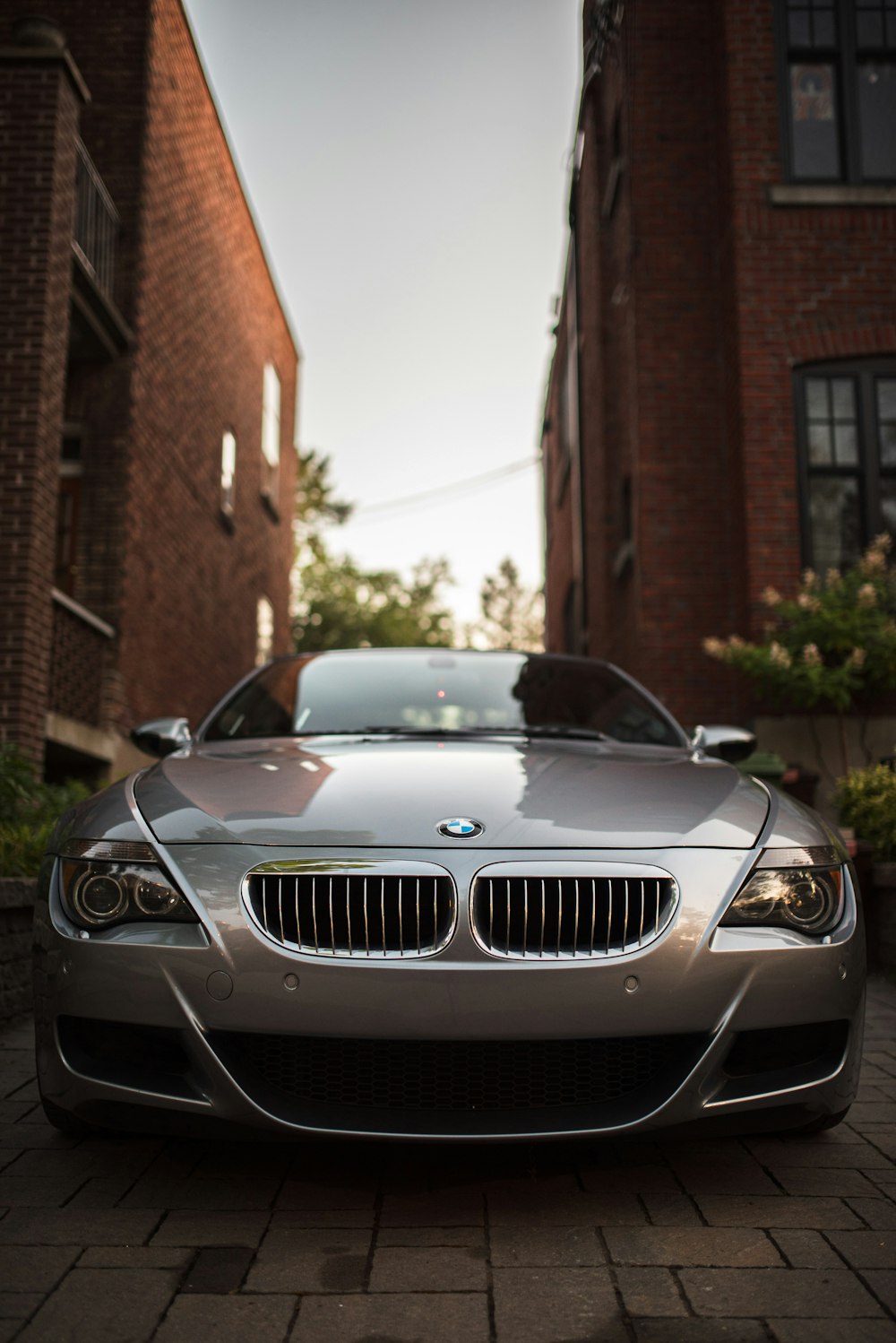 black bmw m 3 coupe parked near brown brick building during daytime