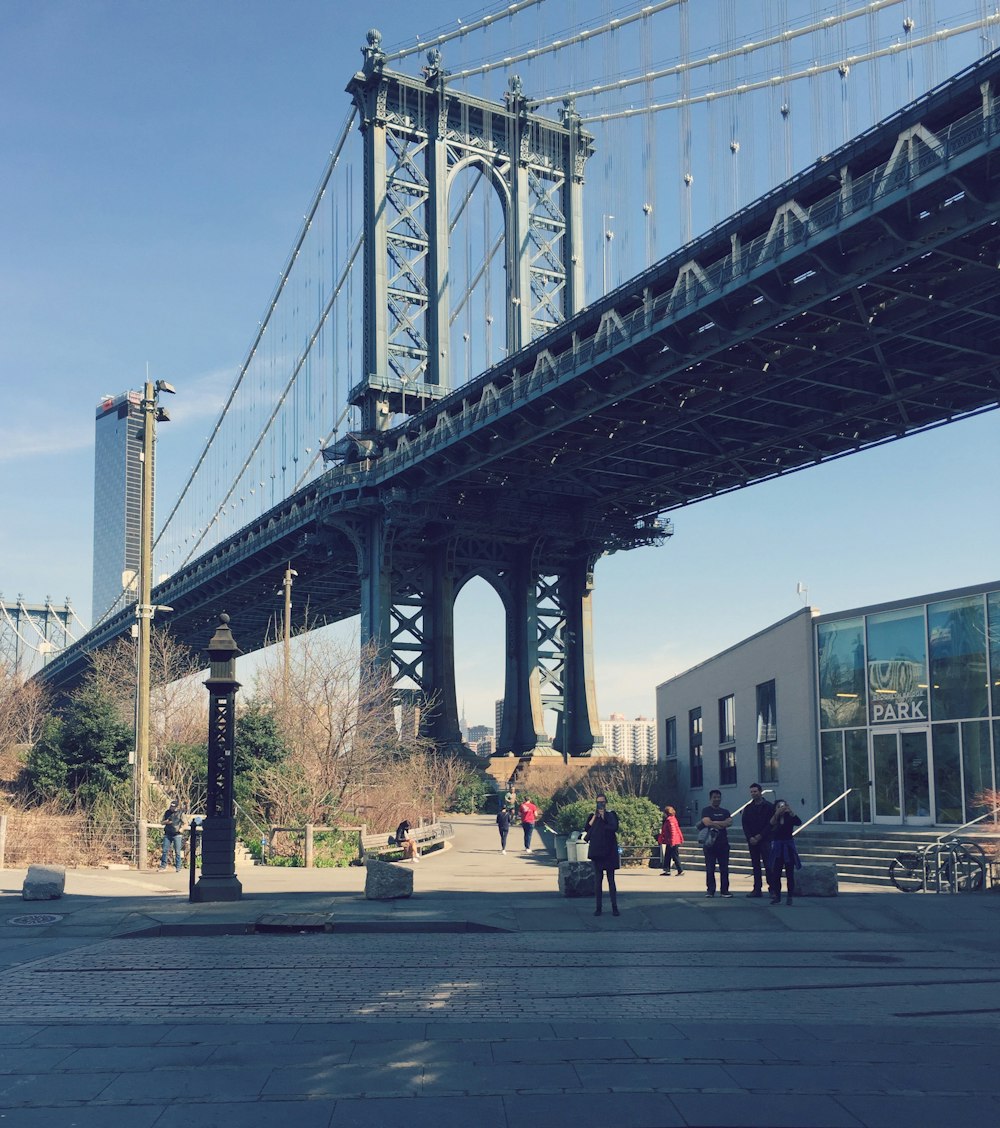 people walking on gray concrete bridge during daytime