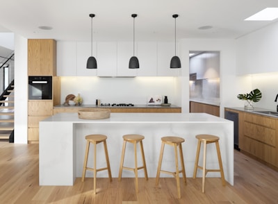 brown wooden seat beside white wooden table