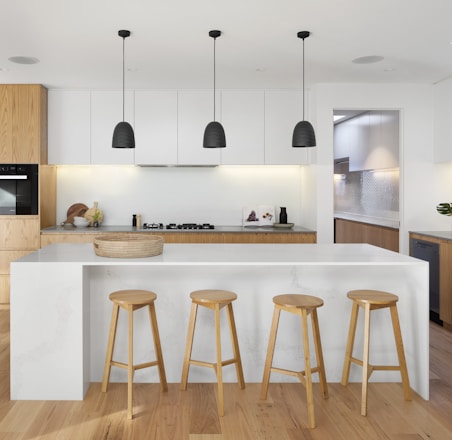 brown wooden seat beside white wooden table