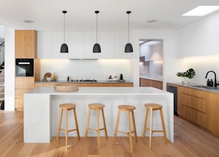 brown wooden seat beside white wooden table