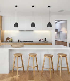 brown wooden seat beside white wooden table