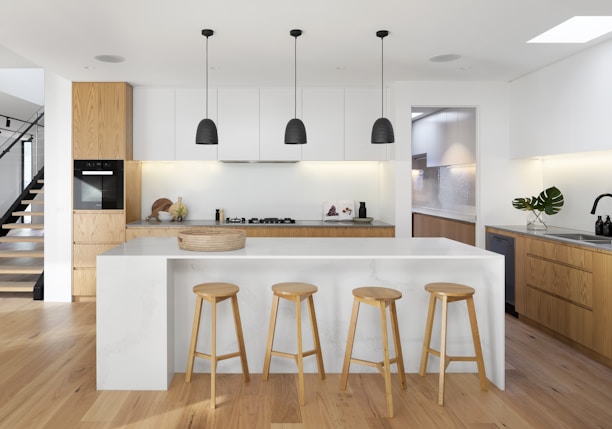 brown wooden seat beside white wooden table