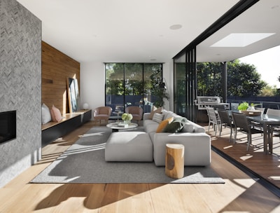 gray sectional couch beside brown wooden table