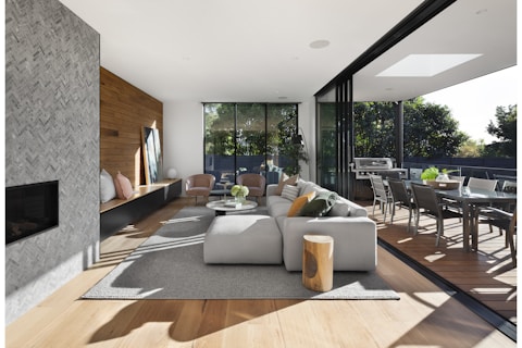 gray sectional couch beside brown wooden table