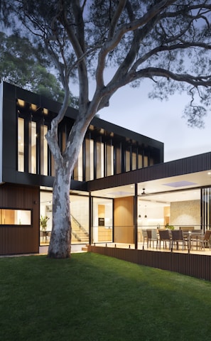 brown and white wooden house near green trees during daytime