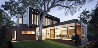 brown and white wooden house near green trees during daytime