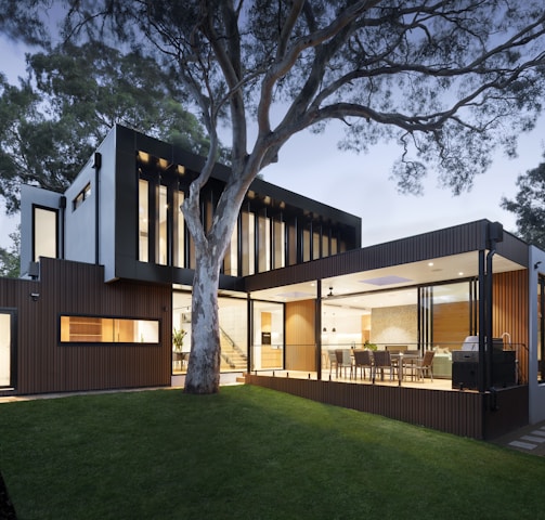 brown and white wooden house near green trees during daytime