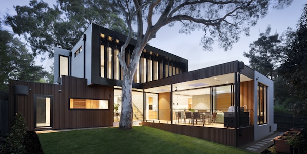 brown and white wooden house near green trees during daytime