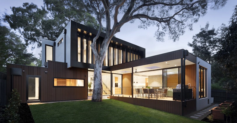 brown and white wooden house near green trees during daytime