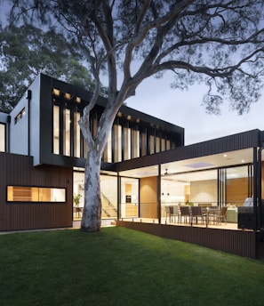 brown and white wooden house near green trees during daytime