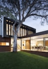 brown and white wooden house near green trees during daytime