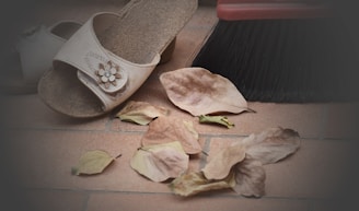 Close-up of vibrant summer sandals resting on warm Indian terracotta tiles.