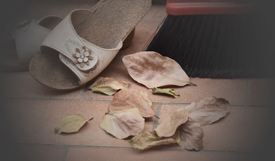 Close-up of vibrant summer sandals resting on warm Indian terracotta tiles.