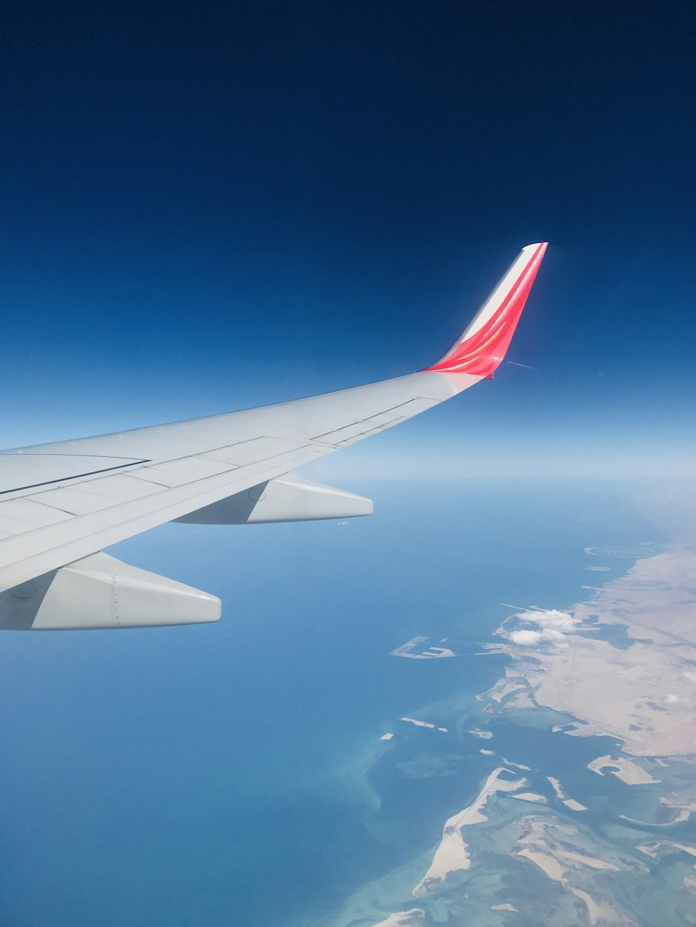 white and red airplane wing