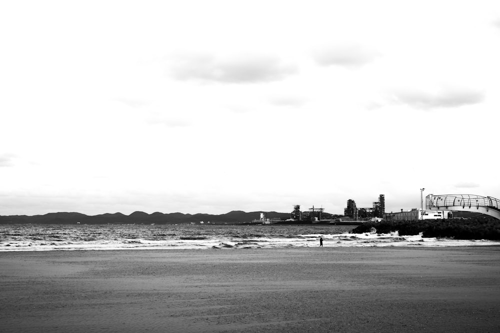 grayscale photo of city buildings near body of water