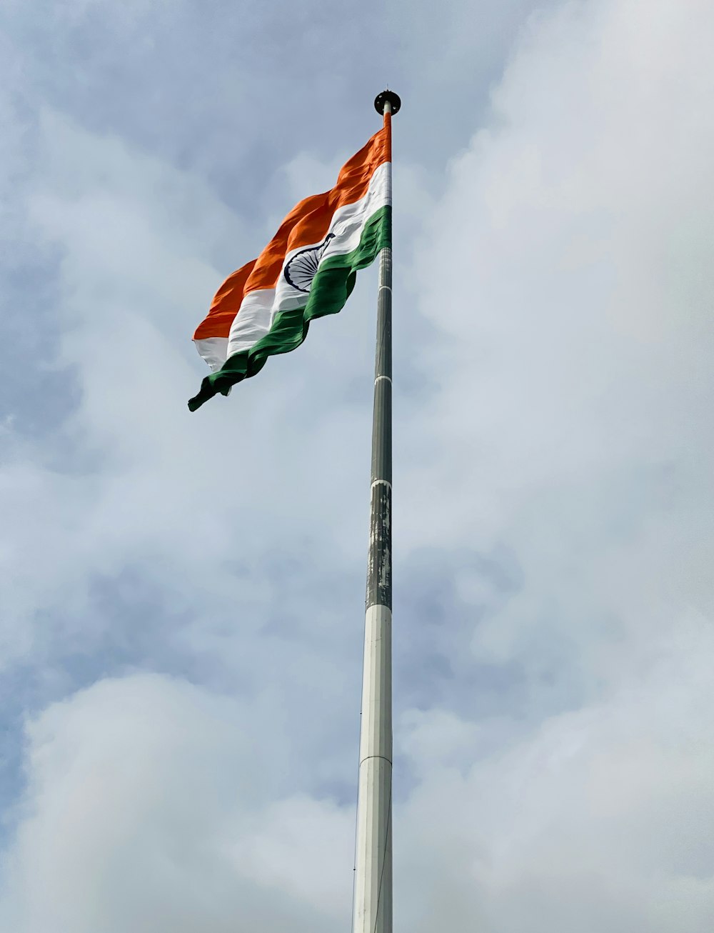 flag of us a on pole under cloudy sky