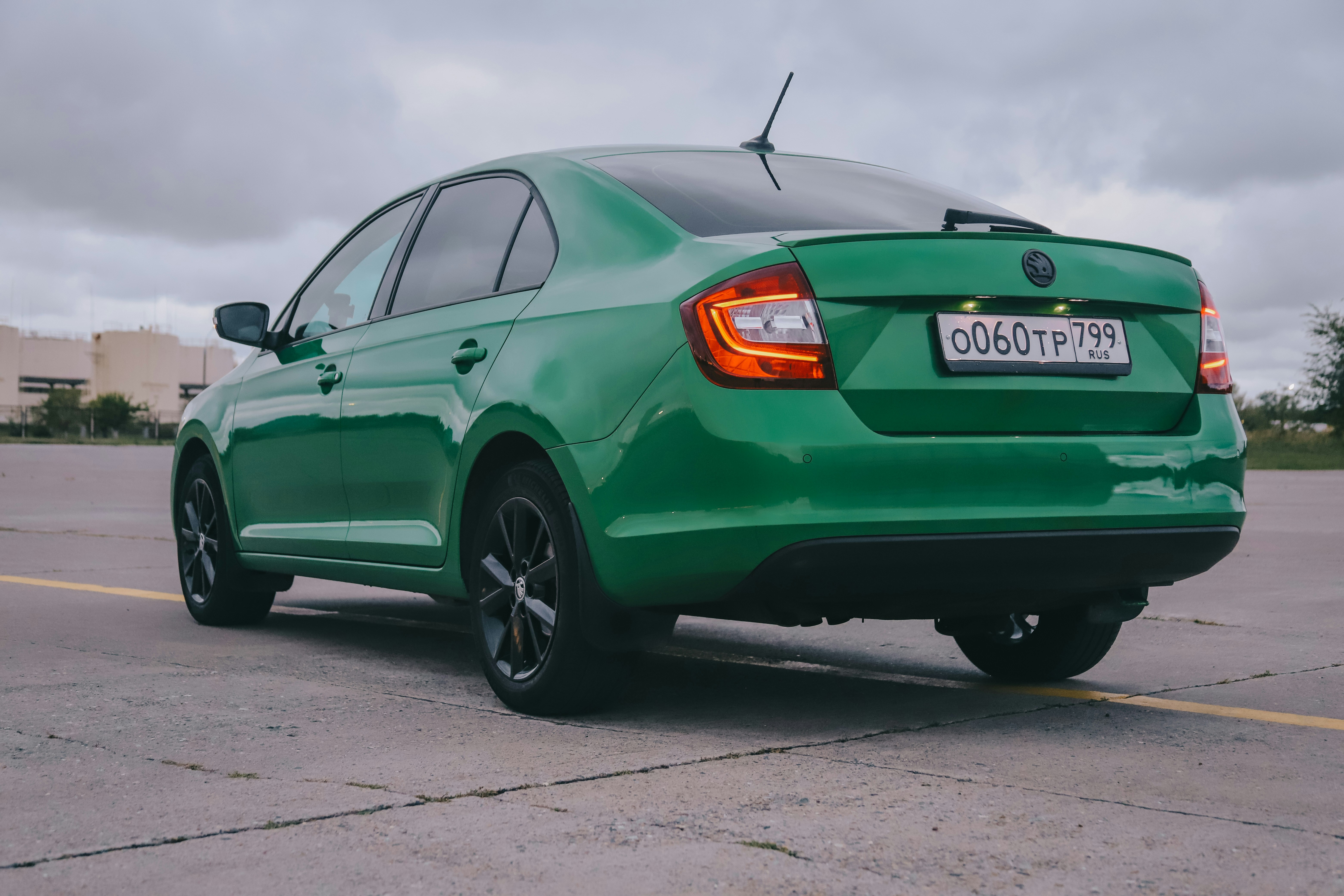 green mercedes benz coupe on road during daytime skoda teams background