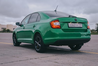 green mercedes benz coupe on road during daytime skoda zoom background