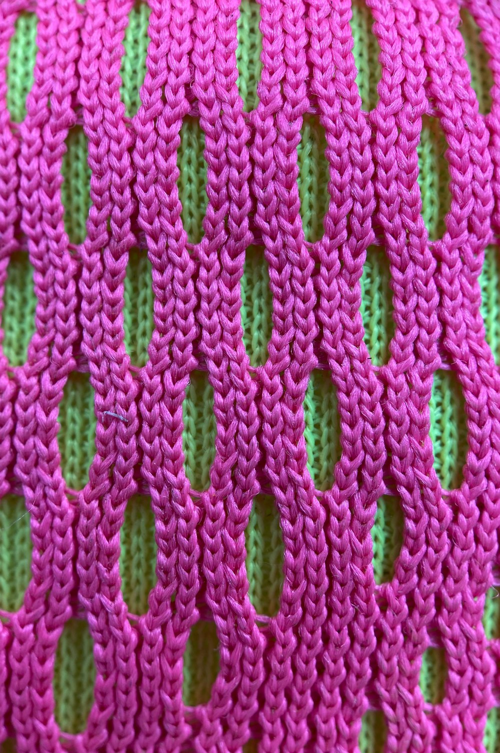 pink and green knit textile