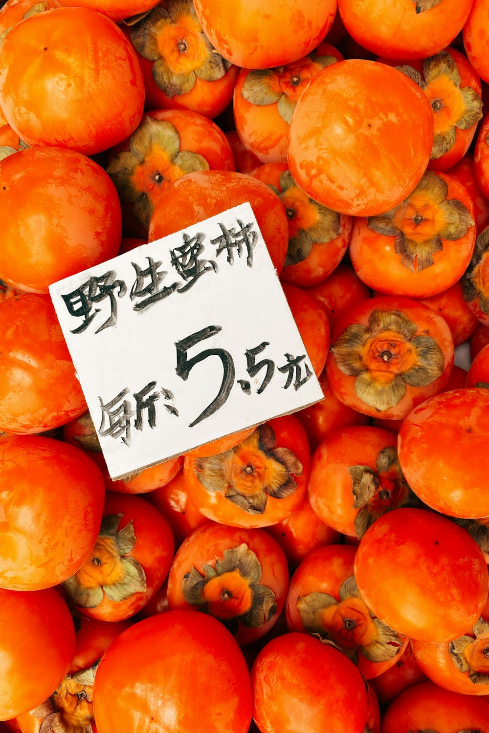 orange fruits on white wooden table