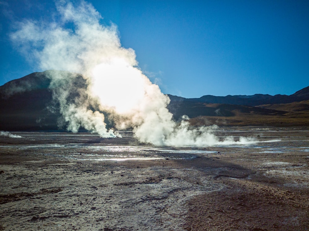 white smoke coming out from a brown field