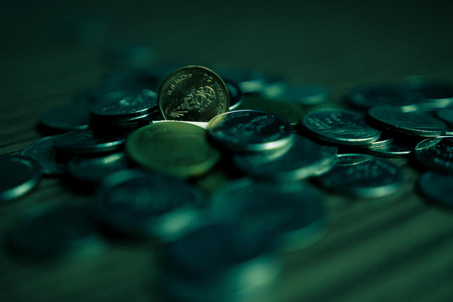 silver round coins on blue surface