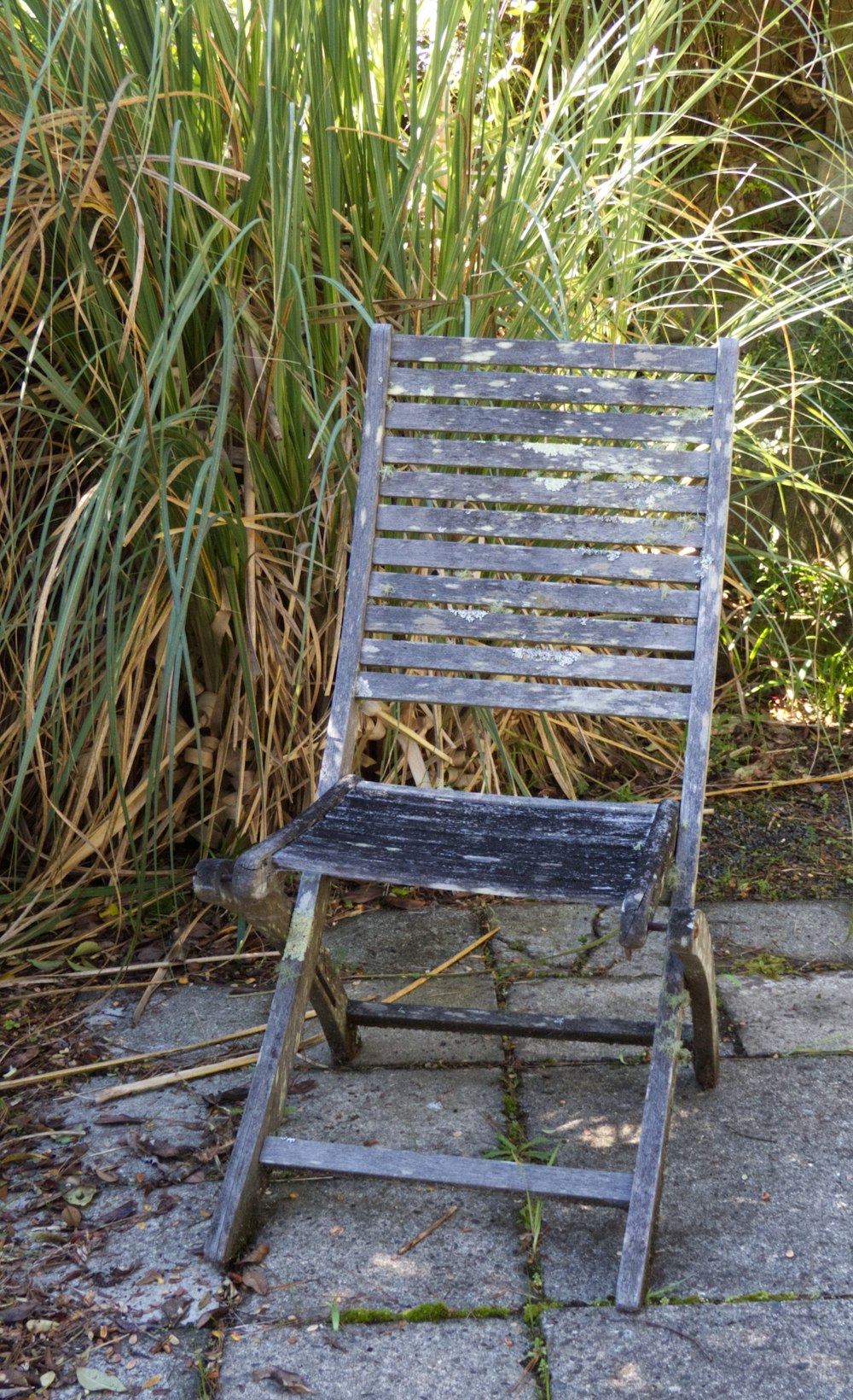 gray metal folding chair on green grass