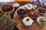 Close-up of a boho-chic buffet station featuring artisanal breads, dips, and fresh fruit arranged on wooden boards.