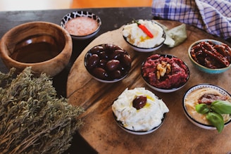 A rustic wooden table set with a variety of homemade breads and dips.