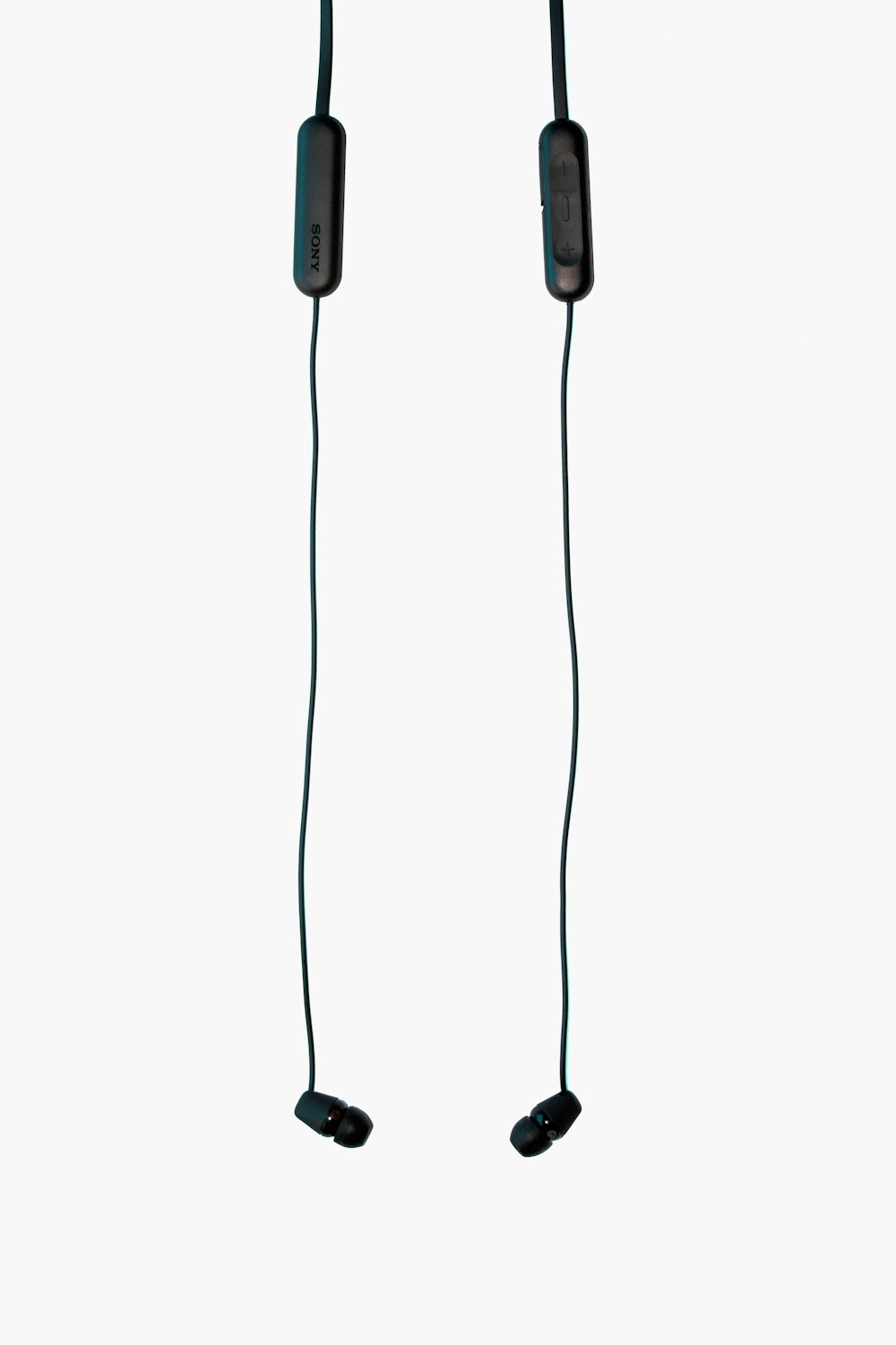 black corded earbuds on white surface