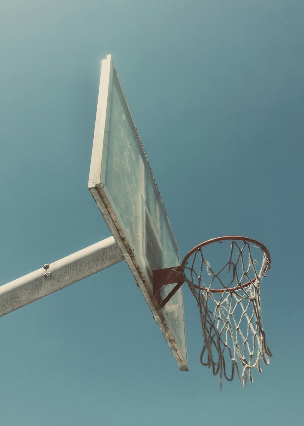 white and red basketball hoop under blue sky during daytime
