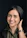 woman in black and gray collared shirt smiling