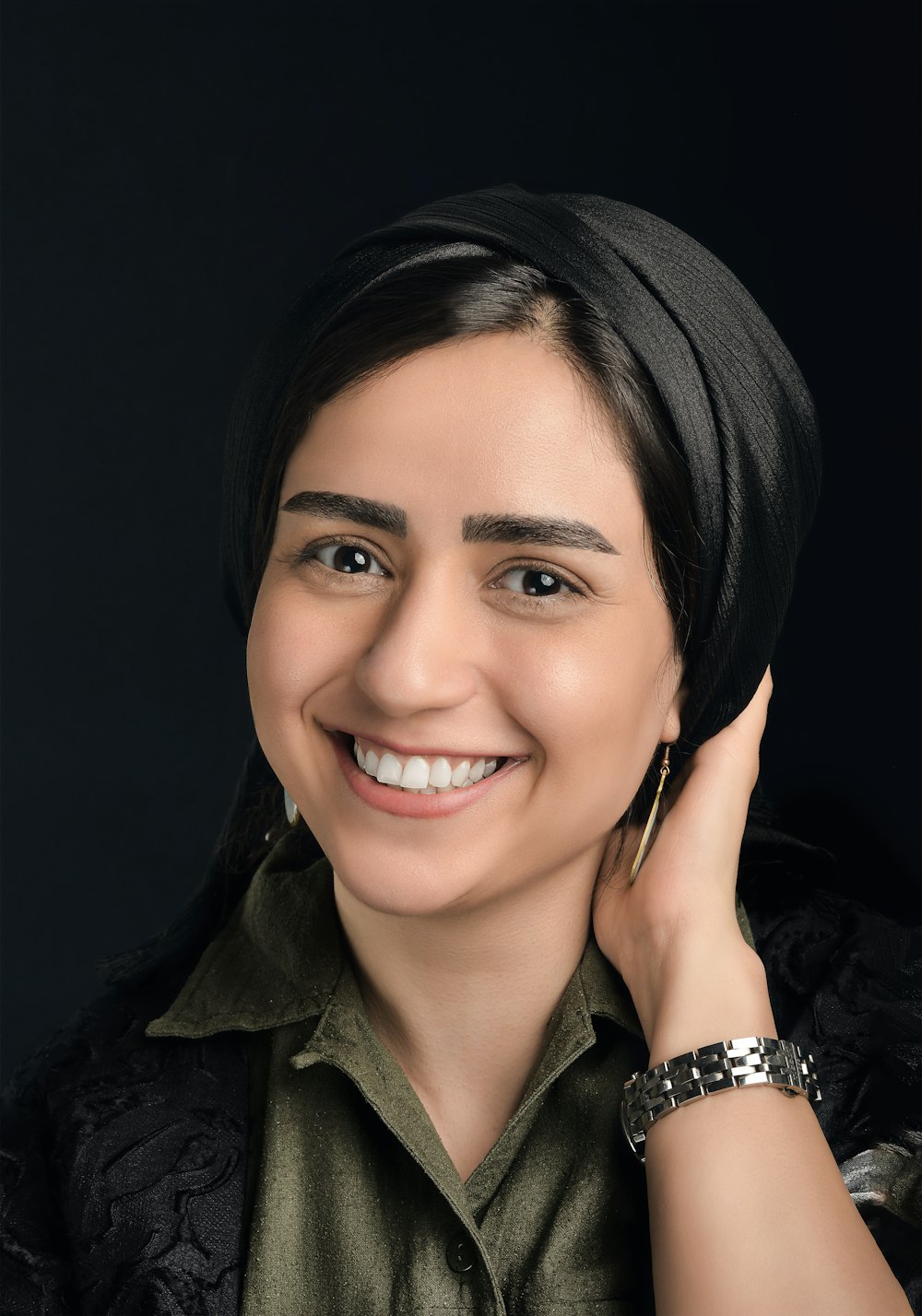 woman in black and gray collared shirt smiling