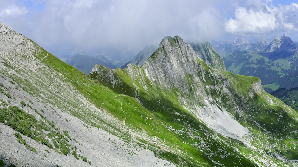 green and gray mountains under white clouds during daytime