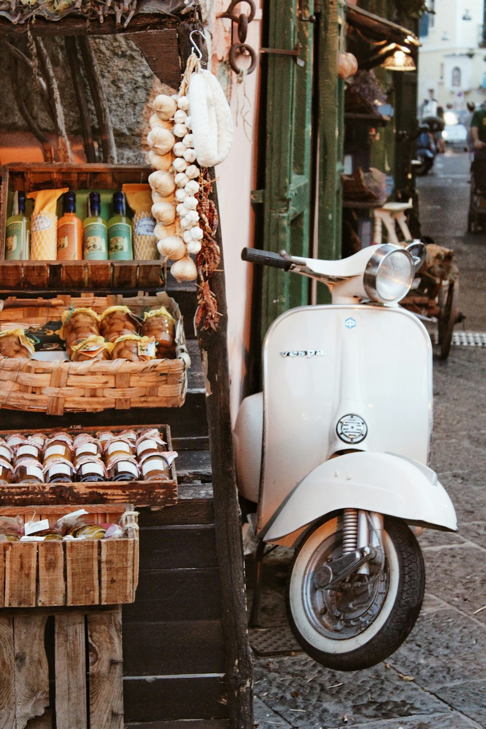 white motor scooter parked beside brown wooden shelf