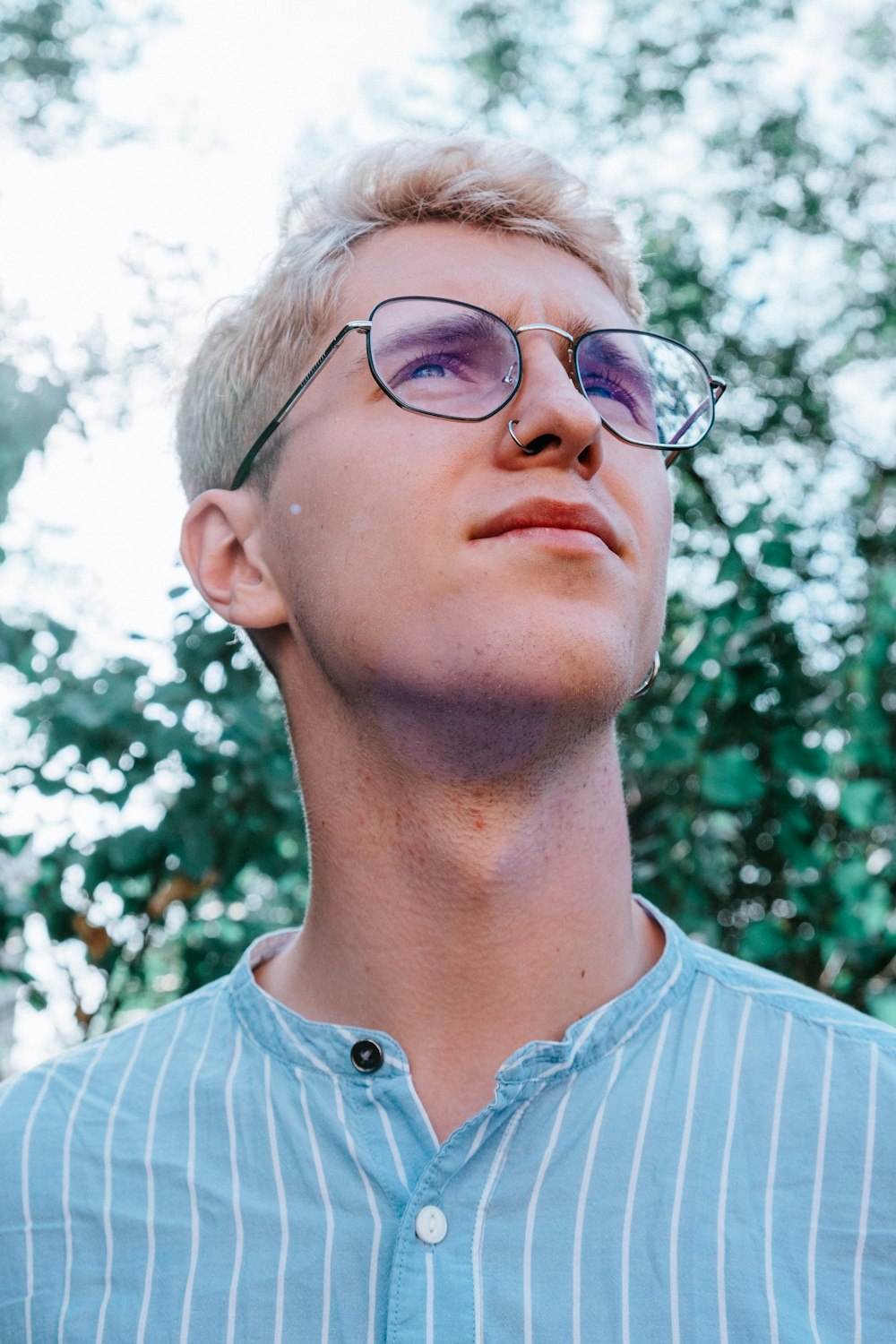 man in blue and white striped shirt wearing eyeglasses