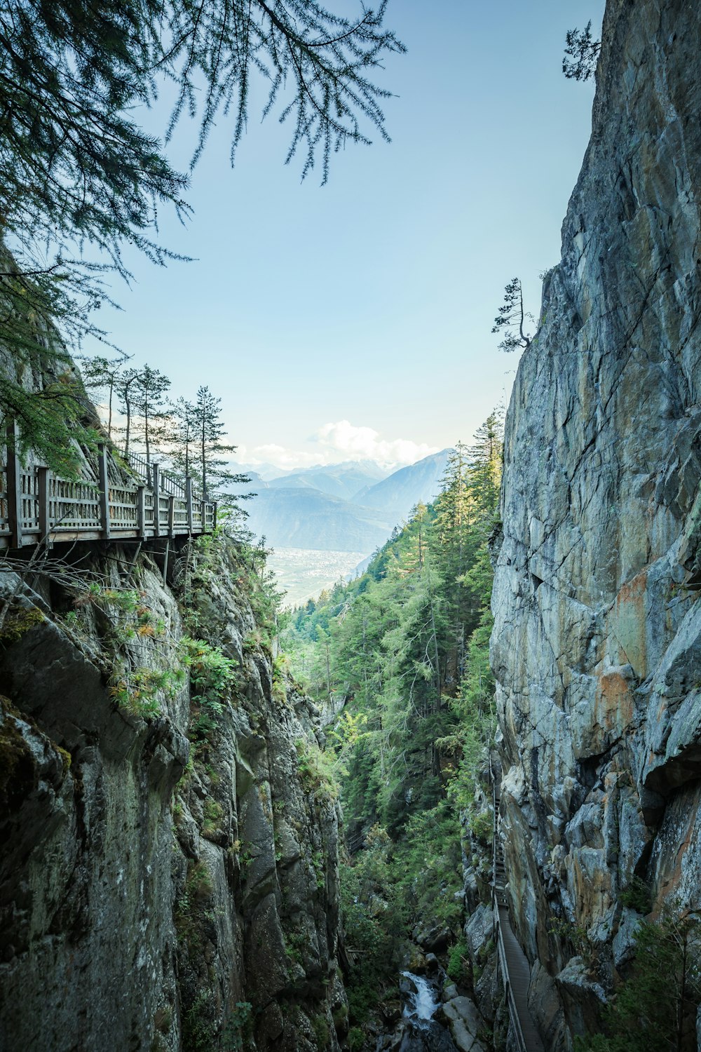 gray concrete bridge on rocky mountain during daytime