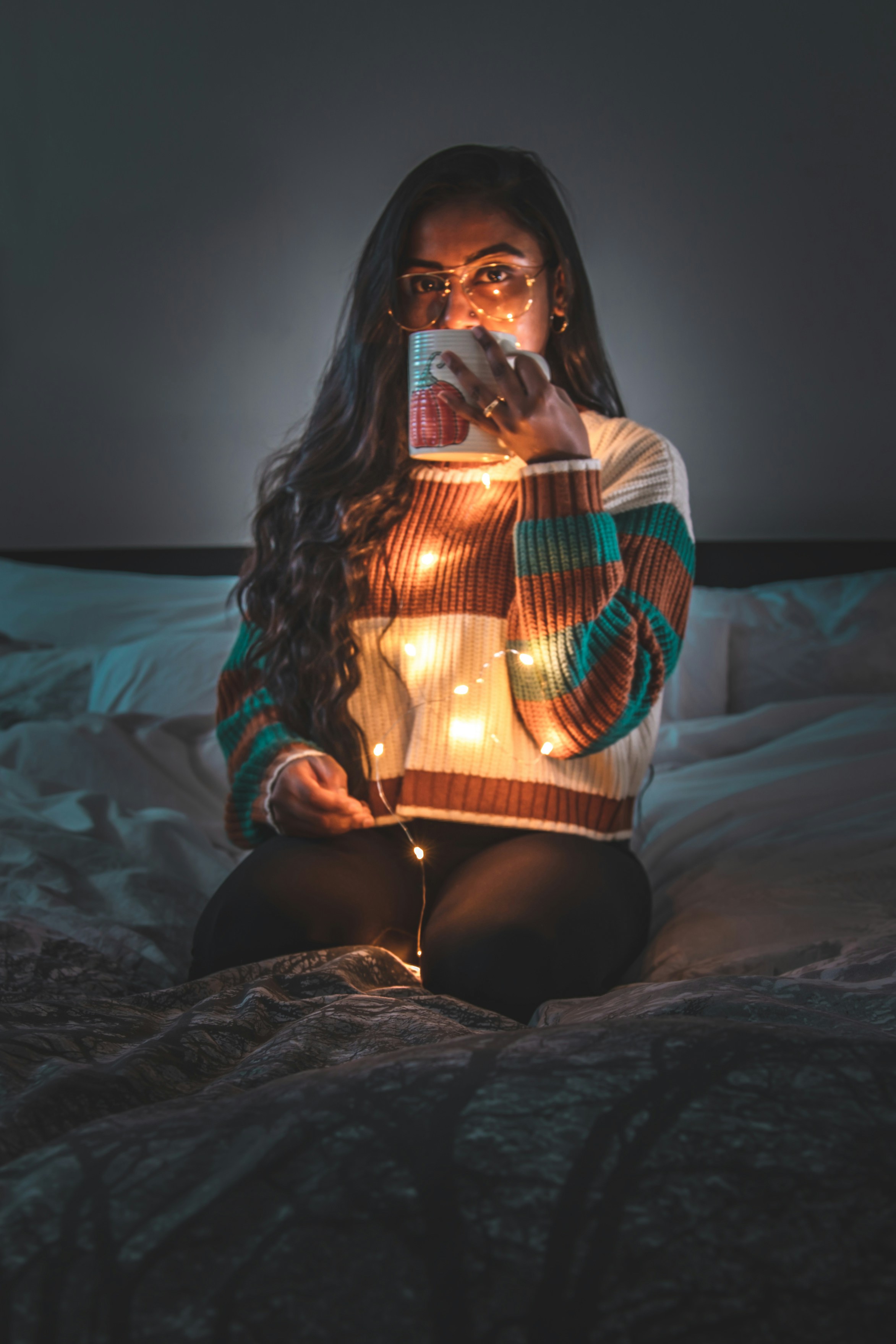 woman in black and red long sleeve shirt sitting on bed