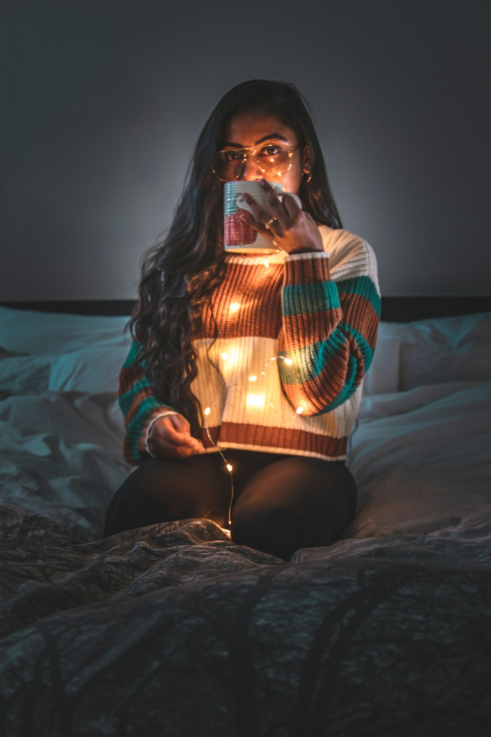 woman in black and red long sleeve shirt sitting on bed