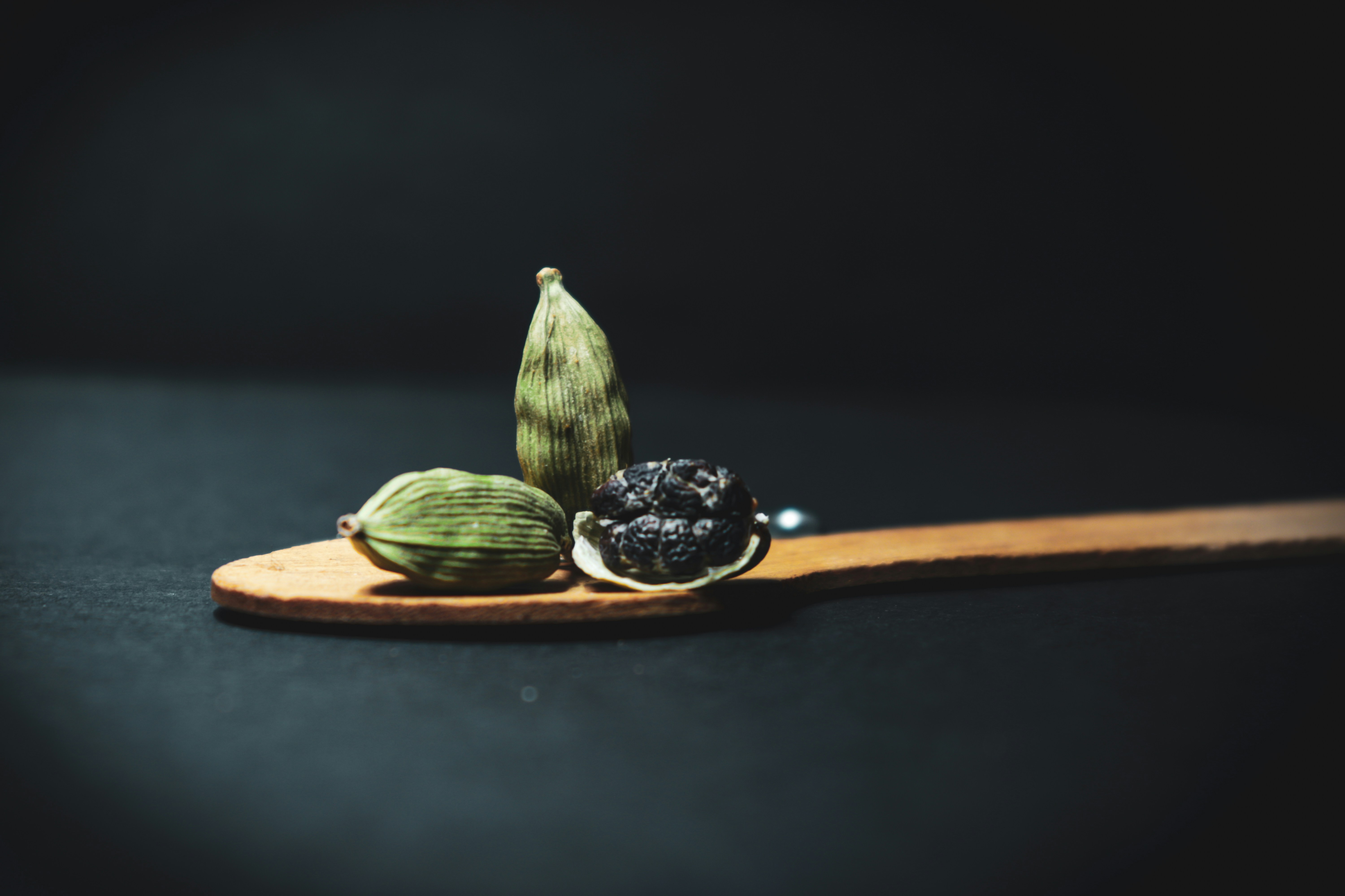 green and brown fruit on brown wooden chopping board