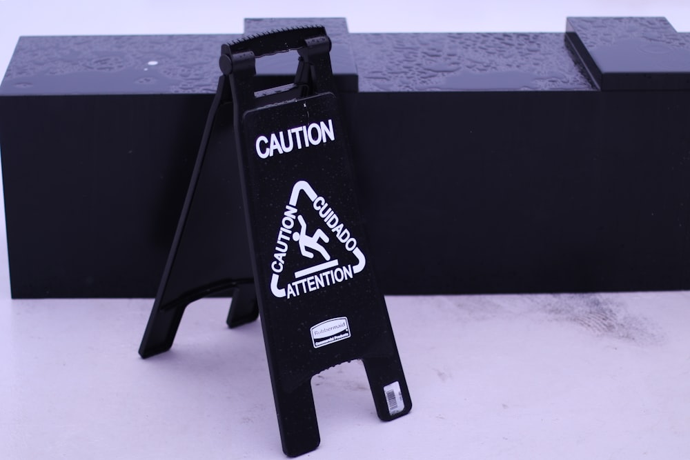 a caution sign sitting on top of a black box