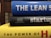 A stack of three books with colorful spines. The top book is blue with the title 'THE LEAN S'. The middle book has a black cover with the word 'startup' written on it and authors listed underneath. The bottom book is yellow, partially showing the title 'THE POWER OF H'. The books are stacked horizontally in a close-up view.
