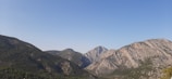 A serene landscape featuring mountains under a clear sky.