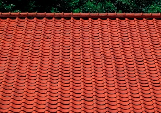 brown roof tiles near green trees during daytime